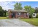 Charming one-story brick home with a cozy front porch and well-maintained lawn at 1416 Chestnut St, Roxboro, NC 27573
