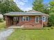 Charming one-story brick home with a cozy front porch and well-maintained lawn at 1416 Chestnut St, Roxboro, NC 27573