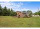 A charming single-story brick home with a well-maintained backyard and patio, perfect for outdoor entertaining at 1416 Chestnut St, Roxboro, NC 27573