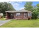 Charming one-story brick home with a cozy front porch and well-maintained lawn at 1416 Chestnut St, Roxboro, NC 27573