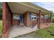 Inviting covered porch featuring brick columns and decorative lattice accents at 1416 Chestnut St, Roxboro, NC 27573