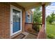 Close up of the covered porch featuring brick columns and decorative lattice accents at 1416 Chestnut St, Roxboro, NC 27573