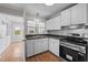 Efficient kitchen featuring white cabinets, stainless steel appliances and dark countertops at 1416 Chestnut St, Roxboro, NC 27573