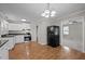Bright kitchen featuring white cabinets and stainless steel appliances with an open floorplan at 1416 Chestnut St, Roxboro, NC 27573