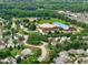 Aerial view features Ballentine Elementary School surrounded by residential area, sports fields, and lush trees at 1514 Hinchliff Ct, Fuquay Varina, NC 27526