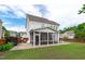 Spacious backyard featuring a screened porch with a fan and a brick patio surrounded by a privacy fence at 1514 Hinchliff Ct, Fuquay Varina, NC 27526