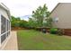 Lush backyard featuring a well-manicured lawn and mature trees at 1514 Hinchliff Ct, Fuquay Varina, NC 27526