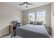 Bedroom with carpet, gray walls, ceiling fan, computer desk, and two windows at 1514 Hinchliff Ct, Fuquay Varina, NC 27526