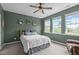 Bedroom features three windows, carpeted floors, ceiling fan and green accent wall at 1514 Hinchliff Ct, Fuquay Varina, NC 27526