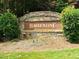 Elegant stone entrance sign for Ballentine community, framed by manicured greenery, creating a welcoming atmosphere at 1514 Hinchliff Ct, Fuquay Varina, NC 27526