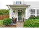 Inviting front porch with rocking chair, hanging plants, and stone accents creating a welcoming entrance at 1514 Hinchliff Ct, Fuquay Varina, NC 27526