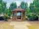 Charming gazebo with wooden benches set amidst lush greenery, ideal for relaxation and gatherings at 1514 Hinchliff Ct, Fuquay Varina, NC 27526