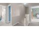 Upstairs hallway with neutral walls and carpet, with views to bedrooms and bathroom at 1514 Hinchliff Ct, Fuquay Varina, NC 27526