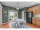 Charming eat-in kitchen with backyard access, oak cabinets, and modern appliances at 1514 Hinchliff Ct, Fuquay Varina, NC 27526