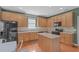 Well-equipped kitchen with oak cabinets, stainless appliances, and a kitchen island at 1514 Hinchliff Ct, Fuquay Varina, NC 27526
