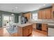 Spacious eat-in kitchen with wooden cabinets, an island, and backyard access at 1514 Hinchliff Ct, Fuquay Varina, NC 27526