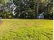Large backyard featuring a shed, lush green grass, and mature trees at 154 Hillsdale Dr, Archer Lodge, NC 27527