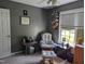 Comfortable bedroom featuring a glider, side table, and wall-mounted bookcase at 154 Hillsdale Dr, Archer Lodge, NC 27527