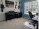 Stylish bedroom featuring an electric piano, guitars, and a large window for natural light at 154 Hillsdale Dr, Archer Lodge, NC 27527