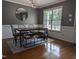 Beautiful dining room featuring a statement mirror, stylish light fixture, and refinished hardwood flooring at 154 Hillsdale Dr, Archer Lodge, NC 27527