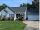 Charming home featuring a well-manicured lawn, attached garage, and delightful front porch at 154 Hillsdale Dr, Archer Lodge, NC 27527