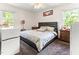 Comfortable bedroom features a large bed, bedside tables, and natural light from the windows at 1709 Whitfield Ave, Rocky Mount, NC 27801