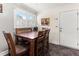 Inviting dining area features a wooden table set near a window and a white entry door at 1709 Whitfield Ave, Rocky Mount, NC 27801