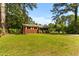 View of a brick house and lawn surrounded by trees at 1709 Whitfield Ave, Rocky Mount, NC 27801