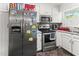 Kitchen featuring stainless steel appliances, white cabinets, and neutral countertops at 1709 Whitfield Ave, Rocky Mount, NC 27801