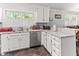 Bright kitchen featuring white cabinets, stainless steel appliances, and a view of the dining area at 1709 Whitfield Ave, Rocky Mount, NC 27801