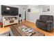 View of a living room showcasing the hardwood floors and television with neutral decor at 1709 Whitfield Ave, Rocky Mount, NC 27801