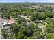 An aerial view showing the neighborhood, including the home, nearby trees, and city in the background at 1812 Hilton St, Raleigh, NC 27608