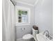 Bathroom with white sink, toilet, vintage tiled floor and light blue walls at 1812 Hilton St, Raleigh, NC 27608