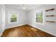 Bedroom with hardwood floors, white walls, ceiling fan and built in shelves at 1812 Hilton St, Raleigh, NC 27608