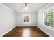 This bright bedroom features gleaming hardwood floors, fresh neutral paint, a ceiling fan and great natural light at 1812 Hilton St, Raleigh, NC 27608