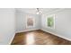 Bedroom featuring hardwood floors, white walls and two windows with natural light at 1812 Hilton St, Raleigh, NC 27608