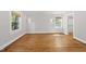 Spacious bedroom featuring hardwood floors, sconce lighting and a view of a walk-in closet at 1812 Hilton St, Raleigh, NC 27608