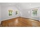 Bright bedroom with hardwood floors, vaulted ceiling, and large windows with natural light at 1812 Hilton St, Raleigh, NC 27608