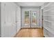 Hallway with french doors, a built-in bookcase and hardwood flooring at 1812 Hilton St, Raleigh, NC 27608