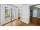 Hallway with french doors, a built-in bookcase and hardwood flooring at 1812 Hilton St, Raleigh, NC 27608
