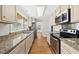 Well-equipped kitchen with stainless steel appliances, granite countertops, and ample storage at 1812 Hilton St, Raleigh, NC 27608