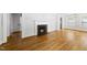 Bright living room featuring a cozy fireplace and gleaming hardwood floors at 1812 Hilton St, Raleigh, NC 27608