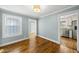Cozy room with blue walls and a view to a bright white kitchen with stainless steel appliances at 1812 Hilton St, Raleigh, NC 27608