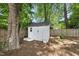 The backyard shed for extra storage and organization surrounded by green grass and a privacy fence at 1812 Hilton St, Raleigh, NC 27608