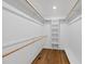 Walk-in closet with custom shelving and rod system over hardwood floors at 1812 Hilton St, Raleigh, NC 27608