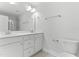 Bright bathroom with double sink vanity, large mirror, and chrome fixtures, with toilet on the right at 1900 Fishamble St # 17, Fuquay Varina, NC 27526
