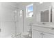 Well-lit bathroom featuring white cabinets, a glass-enclosed shower, and a window at 1900 Fishamble St # 17, Fuquay Varina, NC 27526