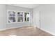 Spacious bedroom with hardwood floors and bright windows providing natural light and backyard views at 1900 Fishamble St # 17, Fuquay Varina, NC 27526