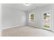 Bright bedroom featuring a door to the outside and a window with a view of the backyard at 1900 Fishamble St # 17, Fuquay Varina, NC 27526