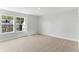 Bedroom features neutral carpet, light gray walls, and a view of the neighborhood through the double window at 1900 Fishamble St # 17, Fuquay Varina, NC 27526